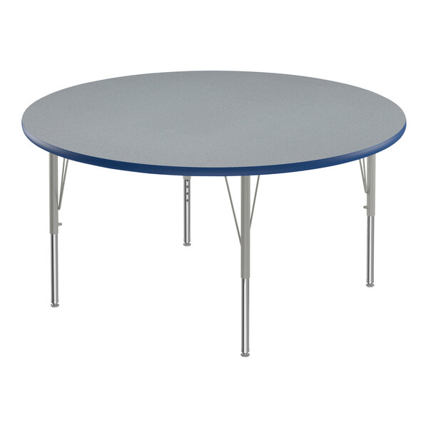 A round Correll activity table with a gray granite top and metal legs with a blue edge.