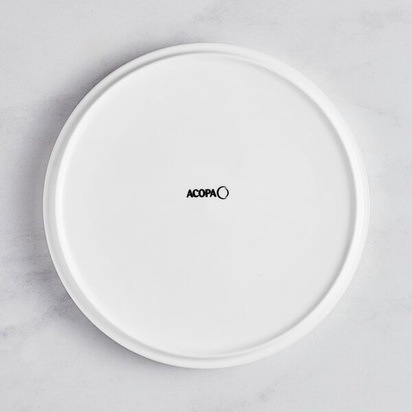 An Acopa Lore bright white porcelain plate with a raised rim.