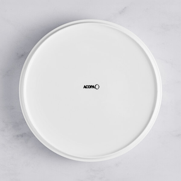 An Acopa Lore bright white porcelain deep plate with a raised rim and black text on it.