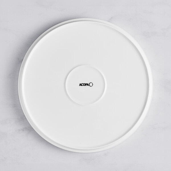 An Acopa Lore bright white porcelain plate with raised rim.