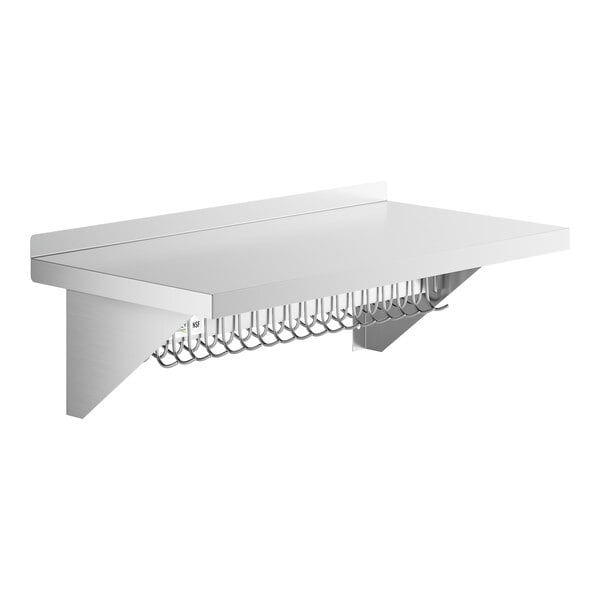 A white shelf with a stainless steel wall-mounted rack and metal hooks.