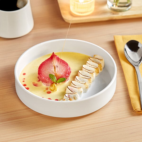 A bowl of food on a white Acopa Lore deep plate with a raised rim.