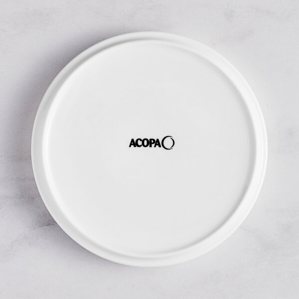 A white Acopa Lore porcelain plate with raised rim and black text.