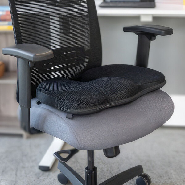 A black Luxor Gelevation chair with a cushion on it.