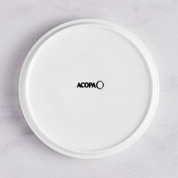 A white porcelain plate with a raised rim and the word "Acopa" in black.