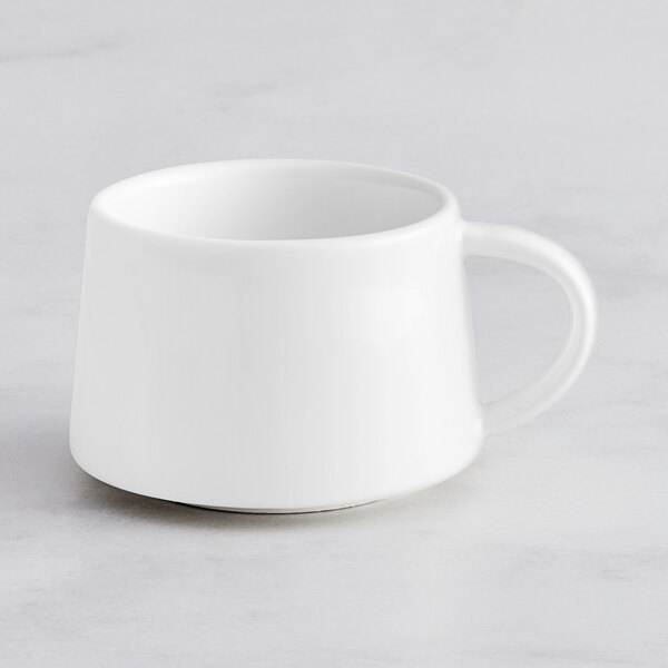 A bright white Acopa Lore espresso cup with a handle.