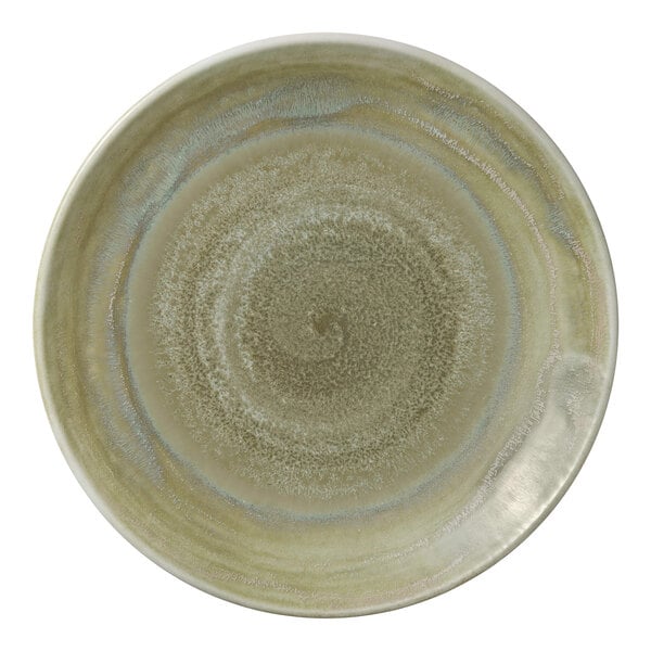 A close-up of a Heart & Soul Thyme porcelain coupe plate with a green swirl design.