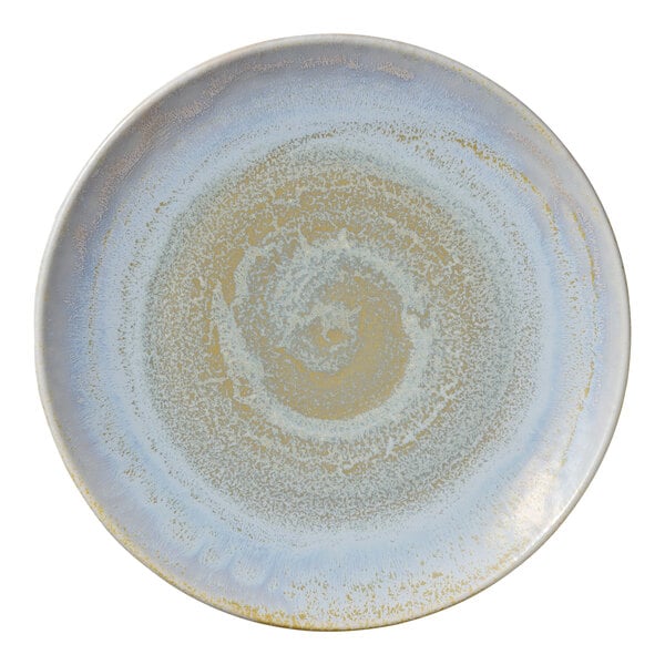 A white porcelain coupe plate with a blue swirl pattern.