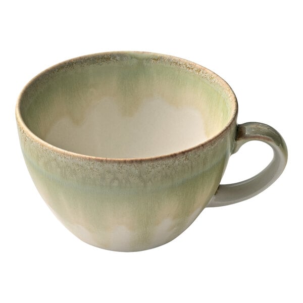 A green and white Heart & Soul porcelain cup with a handle.