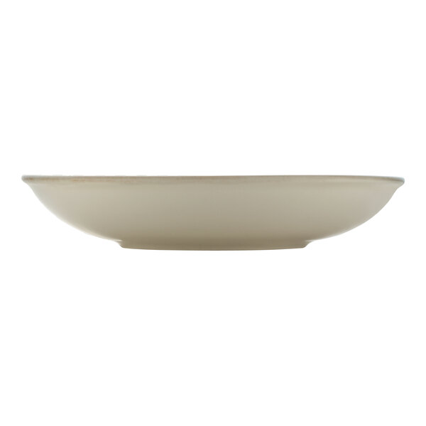 A white porcelain coupe plate with a cumin rim.