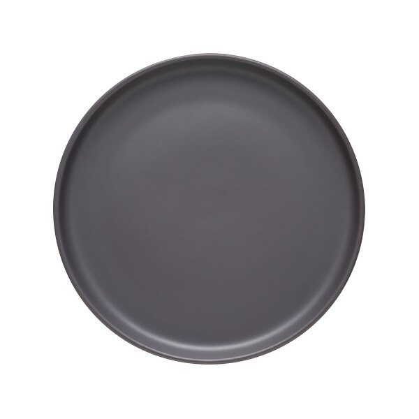 A close up of a black Libbey Driftstone granite satin matte porcelain flat coupe plate.