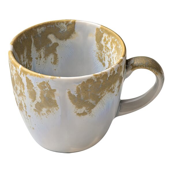 A white porcelain espresso cup with a crackled design and a gold handle.
