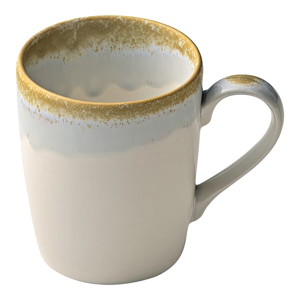 A close-up of a white and gold Heart & Soul coffee mug with a handle.