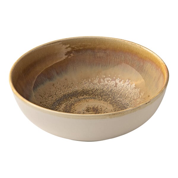 A white porcelain serving bowl with brown speckles and a spiral pattern.