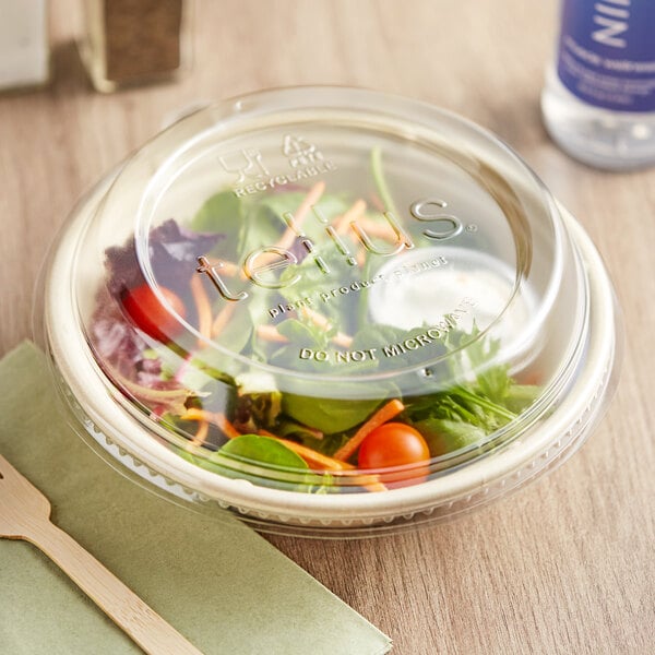 A salad in a bowl with a Tellus Products round plastic lid.