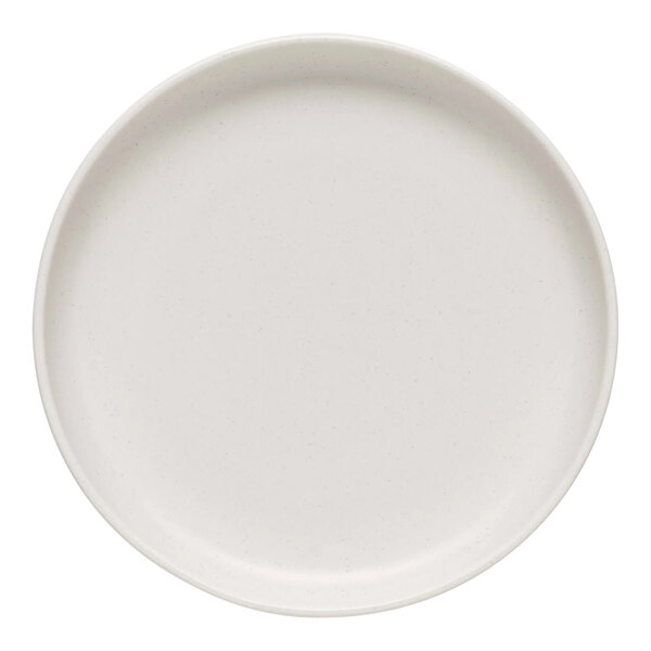 A white Libbey Driftstone porcelain coupe plate with a speckled surface.