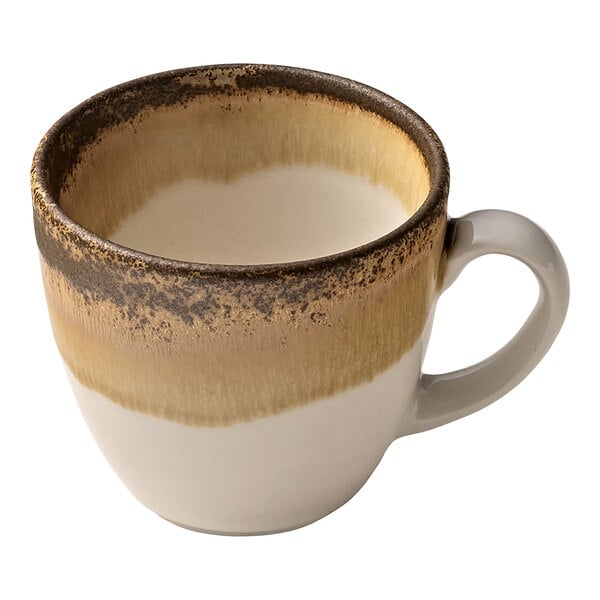 A white porcelain espresso cup with a brown and white design and a handle.