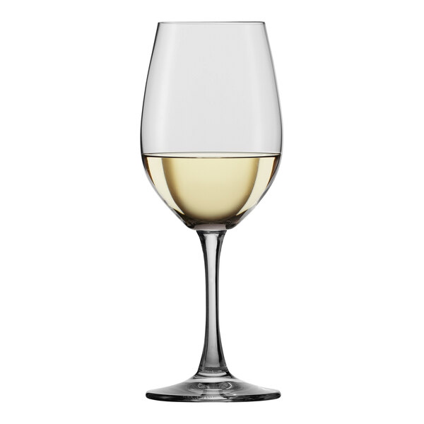 A Spiegelau white wine glass filled with white wine.