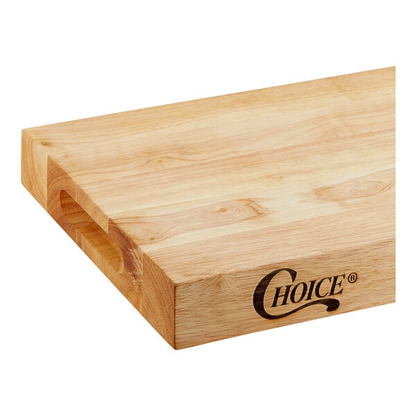 A Choice wooden cutting board with squared edges on a table in a home kitchen.