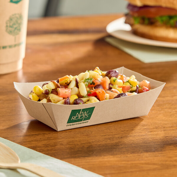 A rectangular compostable bamboo food tray filled with a mixed bean and corn salad.
