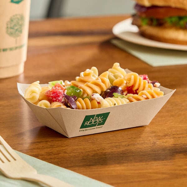A small rectangular compostable bamboo food tray filled with pasta salad.