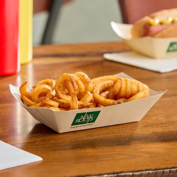 A compostable rectangular bamboo food tray filled with curly fries.