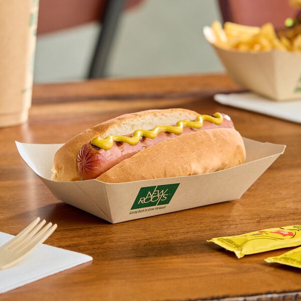 A rectangular compostable bamboo food tray holding a hot dog with mustard.