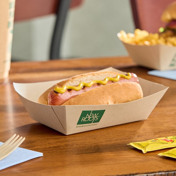 A rectangular compostable bamboo food tray holding a hot dog with mustard.