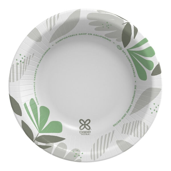 A white paper bowl with green leaves on it.