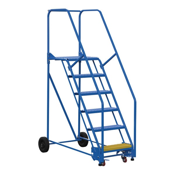 A blue metal Vestil rolling warehouse ladder with black wheels.