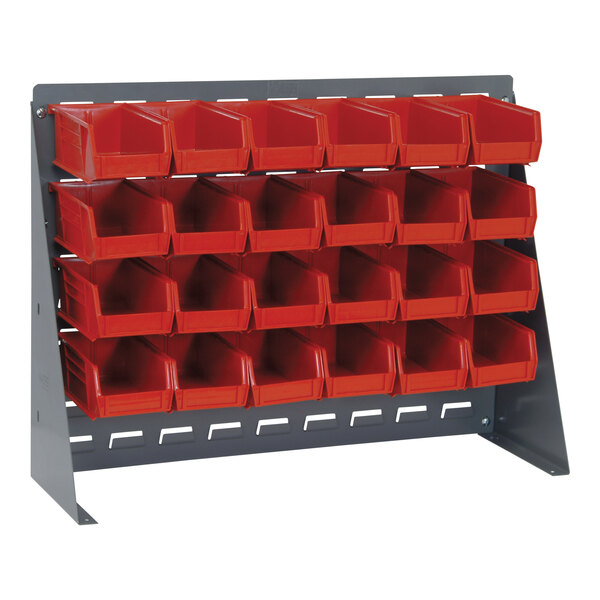 A Quantum steel bench rack with red bins on a metal stand.