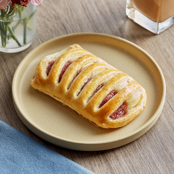 A close-up of a Bridor Strawberry Cheesecake Danish pastry on a plate.