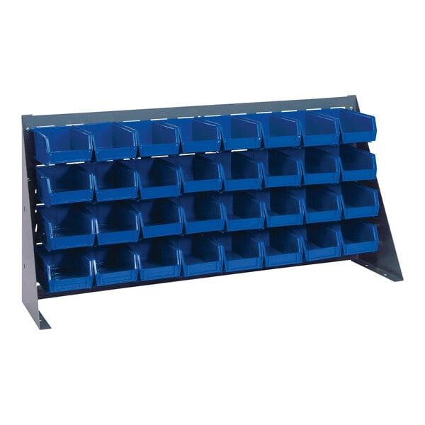 A Quantum gray steel bench rack with blue bins on a white background.