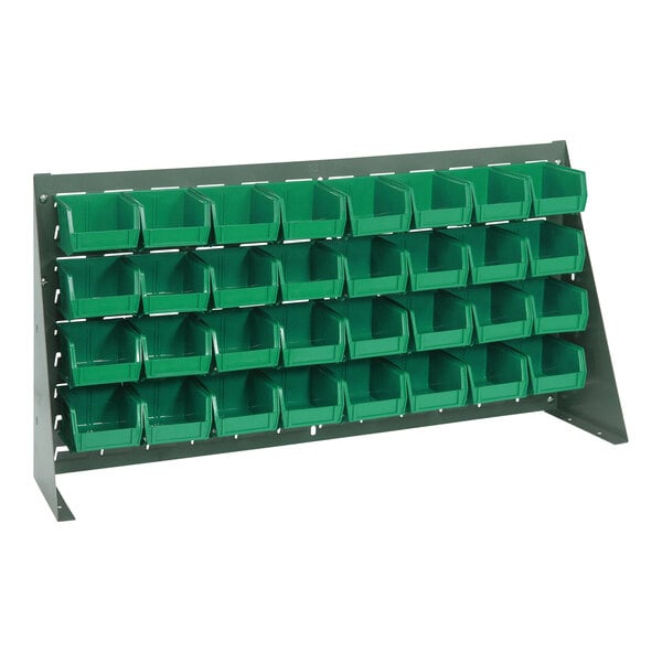 A gray steel bench rack with green Quantum bins on shelves.