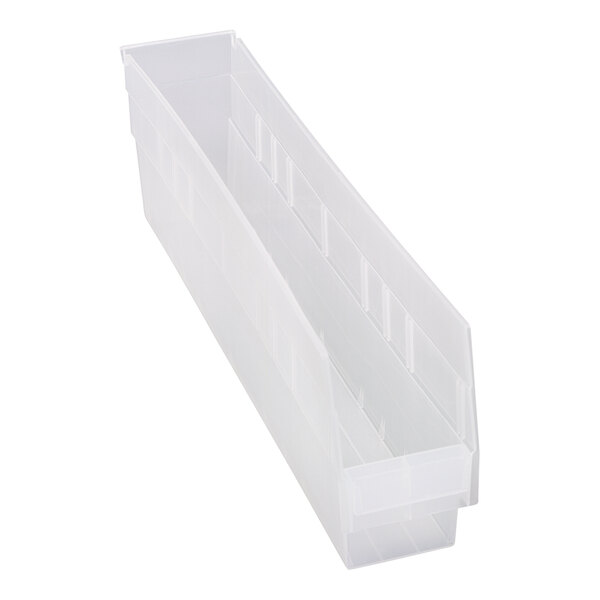 A clear plastic Quantum shelf bin with two compartments.