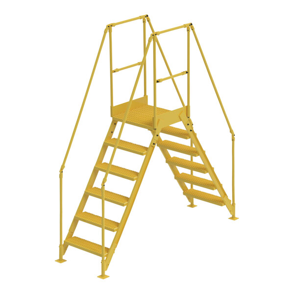 A yellow Vestil steel crossover ladder with handrails and metal steps.