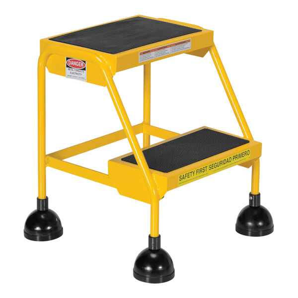 A yellow Vestil step ladder with black rubber feet.