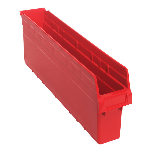 A red plastic Quantum shelf bin with two compartments.