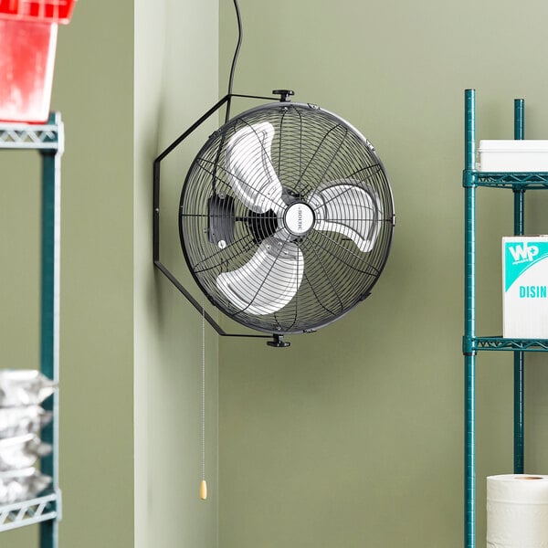 A large black Boltic wall-mounted fan with white blades.