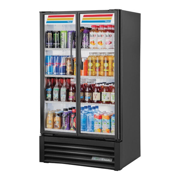 A True Refrigerated Glass Door Merchandiser full of drinks with LED lighting.