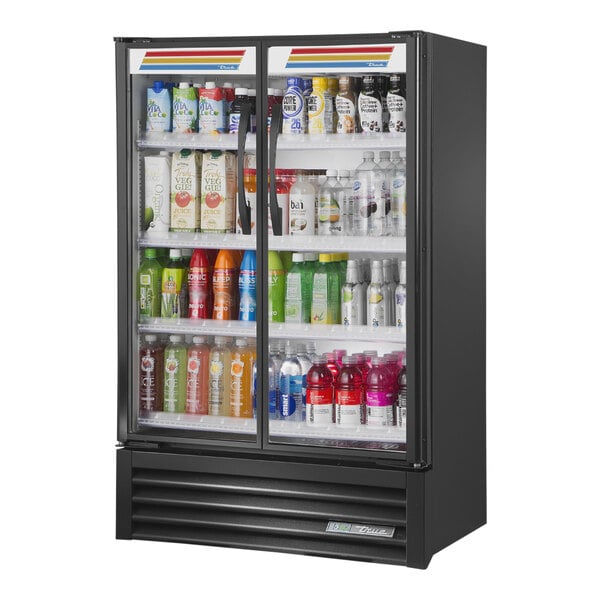 A True black refrigerated glass door merchandiser full of drinks.