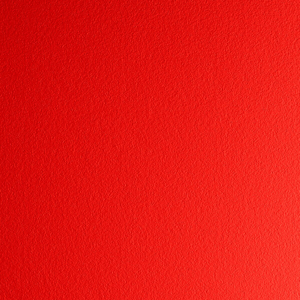 A red resin side chair with a white dot pattern.