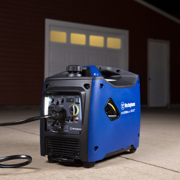 A blue and black Westinghouse portable inverter generator sitting on a driveway.