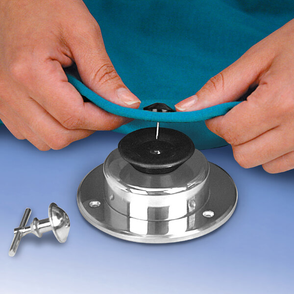 A hand using a Magnetic EAS Security Tag Detacher to hold a piece of metal.