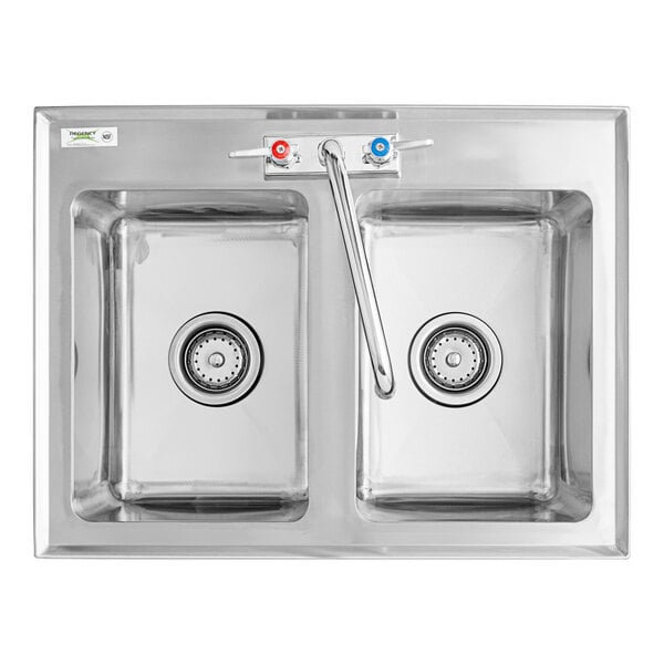 A Regency stainless steel double bowl drop-in sink with two faucets.