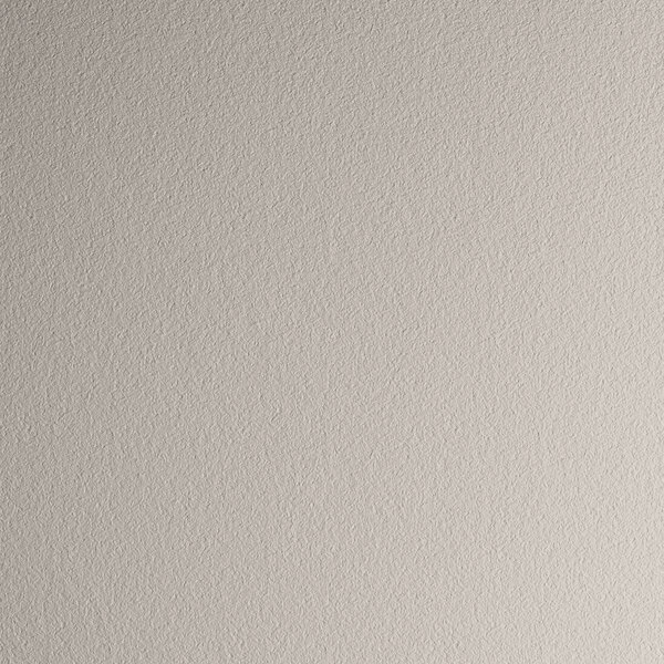 A close up of a white surface with small specks.