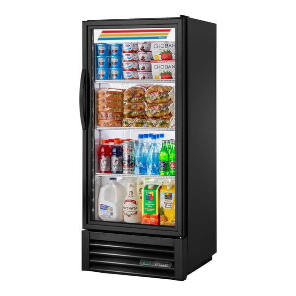 A True refrigerated glass door merchandiser filled with food on shelves.