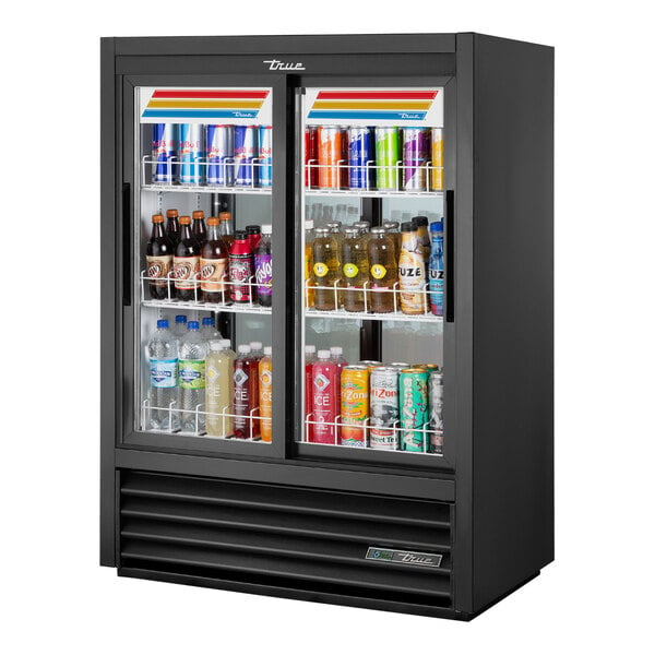 A True 39 1/2-inch black glass door merchandiser with LED lights filled with drinks.