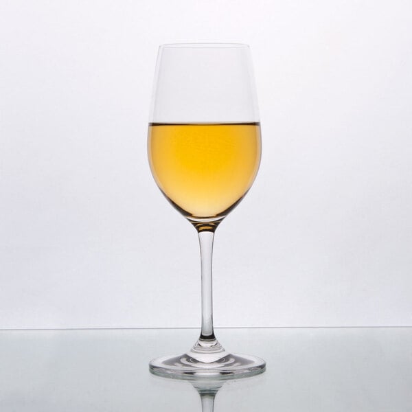 A Stolzle Chardonnay wine glass filled with yellow liquid.