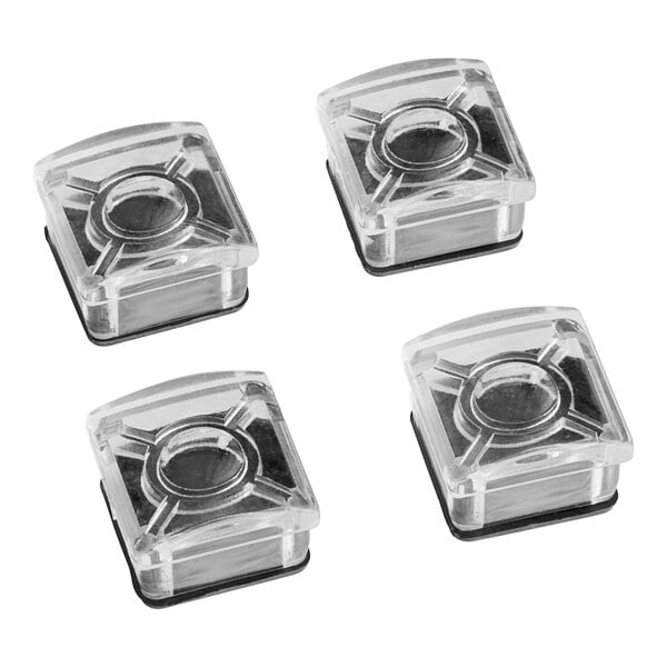 A clear plastic box with four circle-shaped clear plastic chair glides inside.